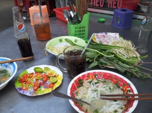 Pho with beef balls, lime and chilli on the side, and a huge plate of herbs (Vinh Long, Mekong Delta)